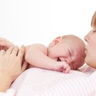 Mother breast feeding baby girl