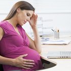 Stressed pregnant woman lying in bed