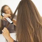 Oil pouring onto woman's forehead and hair