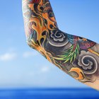 Tattooist Tattooing a Woman's Arm