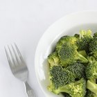 Frozen broccoli pieces on a white plate