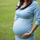 Pregnant women have a water bottle in hand.