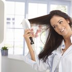 Hairstylist drying woman's hair