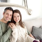 Couple sitting in Bed, Man Massaging shoulders of woman