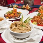 Three People Enjoying a Meal in a Chinese Restaurant