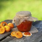 Strawberry jam, fresh strawberries on wooden background