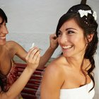 bridesmaid adjusting the bride's wedding gown