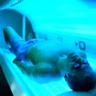 high angle view of a man lying in a tanning machine