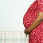 Pregnant woman looking in refrigerator