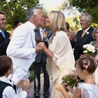 Bride and groom walking under arms of wedding guests