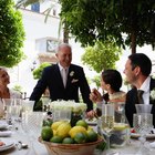 portrait of a newlywed couple standing with their parents