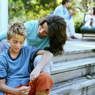 Five children (7-12) with fingers over eyes, portrait (lens flare)