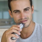 Man using electric shaver