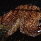 Grilled beef liver kebabs on a dark wooden background