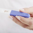 Woman holding positive pregnancy test