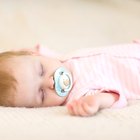 Baby sleeping peacefully in a white bed