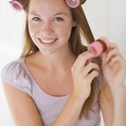 Woman smiling with curling iron