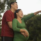 Cropped pregnant woman touching belly