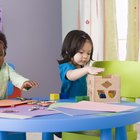 Toddlers coloring and playing with blocks at daycare