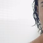 portrait of happy young woman playing with foam in bathtub