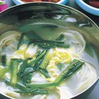 Egg drop soup in a bowl garnished with green onion