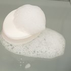 portrait of happy young woman playing with foam in bathtub