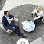 Businessmen in discussion as they walk down staircase