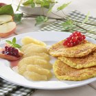 Toasted scone with apple butter on plate in home kitchen