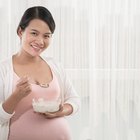 pregnant woman cooking at kitchen