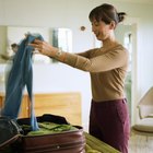 Young woman packing her luggage