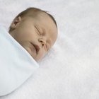 Mother breast feeding baby girl