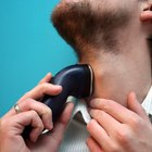 Man using electric shaver