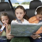 Girl (6-8 years) sitting on rear seat of car, close-up, side view