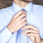 Woman putting boutonniere in man's buttonhole