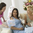 Smiling pregnant couple lying together in bed