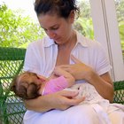 Close up of newborn baby in mother's arms