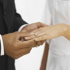 Close-up of two people's hands wearing wedding rings