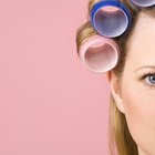 low angle view of a mother putting curlers in her daughter's hair