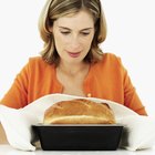 Woman making bagels, kneading dough, close up