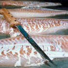 Fresh white fish fillets on chopping board