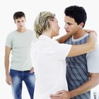 Hispanic Couple Sitting On Sofa Arguing