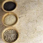 Boiled white rice in ceramic pot on wooden background.