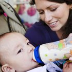 Woman feeding a newborn baby from a bottle