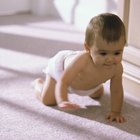 african american mother changing baby's diaper