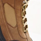 Man sitting on shoeshine chair, close-up, low section