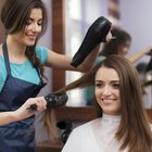 Hairstylist drying woman's hair