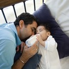 Mother feeding baby with milk bottle