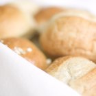 Woman making bagels, kneading dough, close up