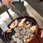 Two men grilling chicken