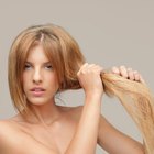 Woman straightening hair with straightener.